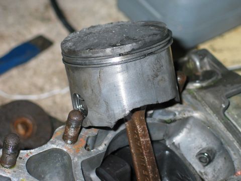 1990 Ford Mustang - A close-up view of a damaged piston and connecting rod, indicating engine failure.