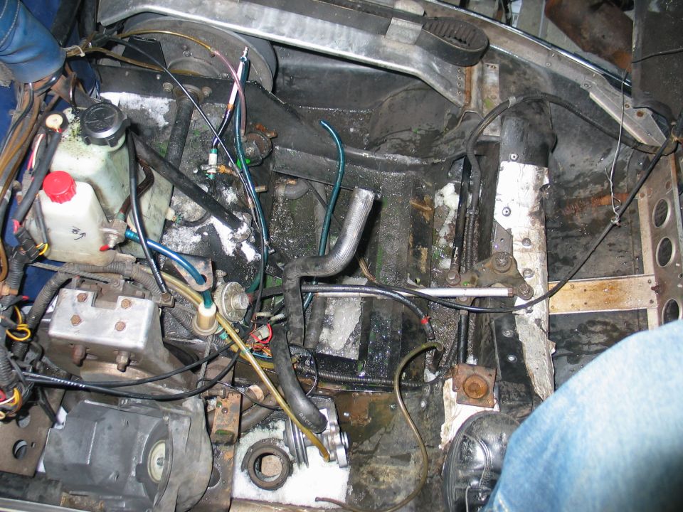 Snowmobile engine compartment with hoses, wires, and mechanical parts