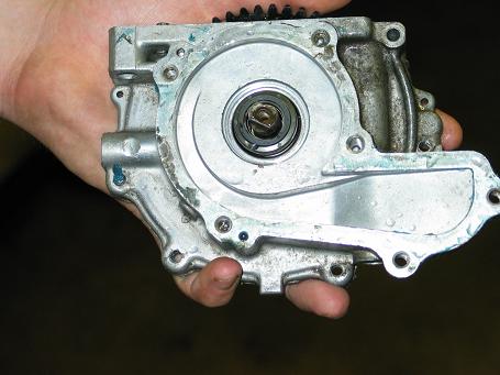 1990 Ford Mustang - Close-up of an automotive oil pump assembly being held in a hand.