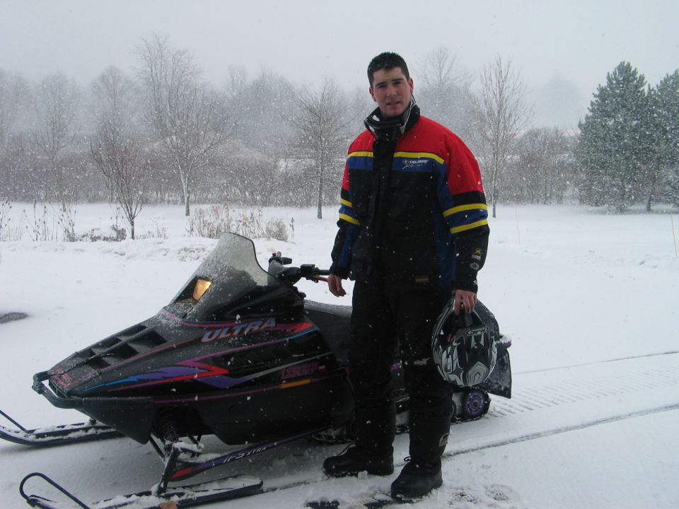 Snowmobile with rider in snowy weather
