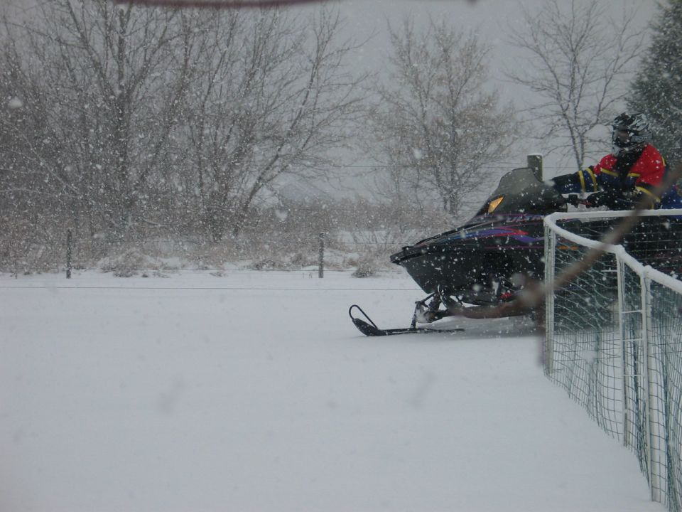 Snowmobile in a snowy landscape with a rider