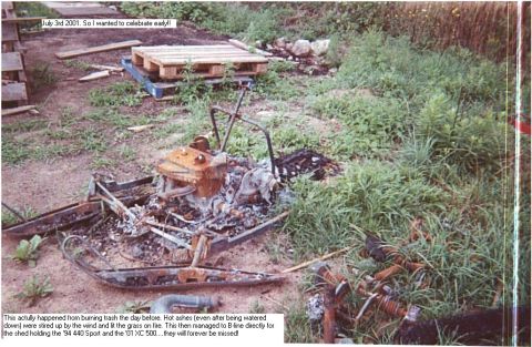 1990 Ford Mustang - A snowmobile is shown after being damaged by fire, with grass and debris around it.