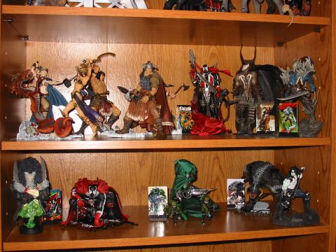 1991 Ford Bronco - A collection of action figures, including fantasy and comic book characters, displayed on wooden shelves.