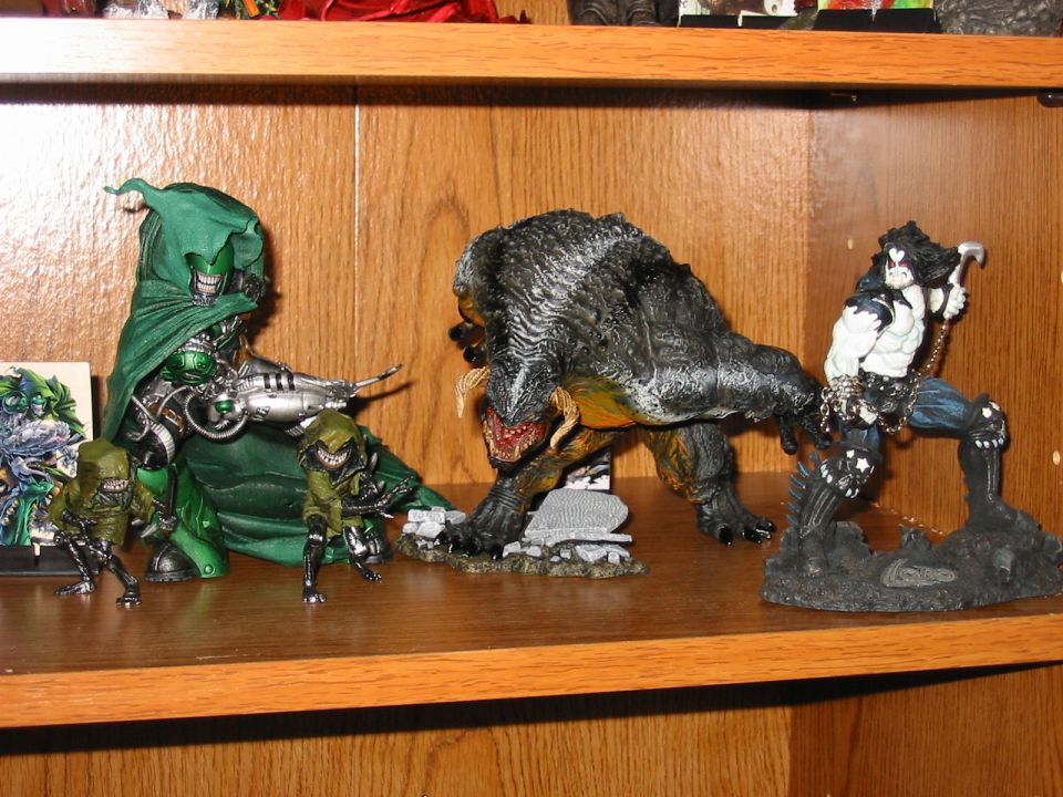 Action figures including Doctor Doom, a monster, and Lobo on a shelf