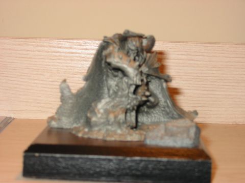 1991 Ford Bronco - Metal figurine on a dark wooden base, possibly a collectible or award.