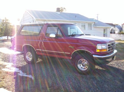 1995 Ford Bronco - This red Ford Bronco has a distinctive body style from the early to mid-1990s.
