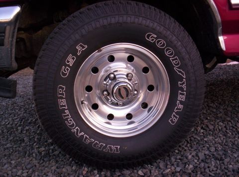 1995 Ford Bronco - Close-up of a vehicle's wheel and tire assembly, showing the tread and rim details.