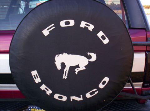 1995 Ford Bronco - The spare tire cover on this Ford Bronco features the iconic running horse logo and the 'Ford Bronco' text.