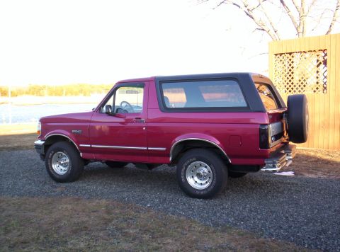 1995 Ford Bronco - This 1995 Ford Bronco is shown from the side, parked outdoors on a gravel surface.