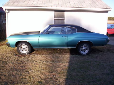 1971 Chevrolet Chevelle - Side view of a blue 1970 Chevrolet Chevelle coupe with a black vinyl top and aftermarket wheels.
