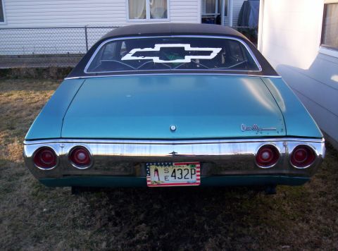 1971 Chevrolet Chevelle - Rear view of a teal 1971 Chevrolet Chevelle, a black vinyl roof and a large bowtie decal.