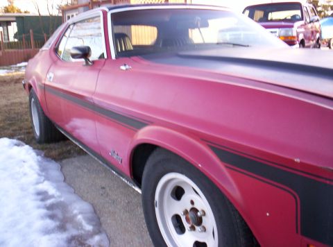 1971 Ford Mustang - The side profile of a 1971 Ford Mustang Grande shows its distinctive body lines and racing stripes.