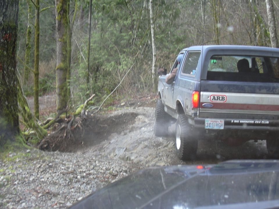Rear view of blue 1991 Ford Bronco with ARB sticker and "BIG BRONCOS 4X4 CLUB" plate frame