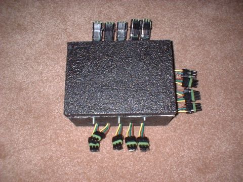 1986 Ford F-250 - This black electronic control module features numerous wire harnesses for various connections.