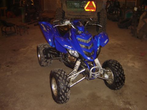 1992 Ford Bronco - A blue Yamaha ATV is parked indoors, with a tractor visible behind it.