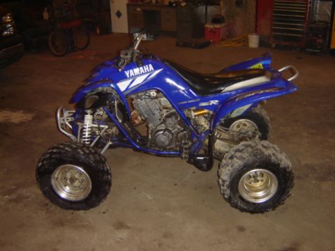 1992 Ford Bronco - A blue Yamaha ATV is parked inside a garage or workshop.