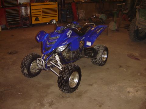 1992 Ford Bronco - A blue Yamaha ATV is parked inside a garage with various tools and equipment visible.