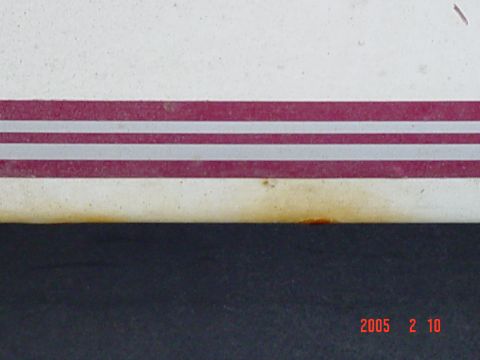 1994 Ford Bronco - A close-up shows a red and silver stripe on a white vehicle, with a timestamp in the corner.