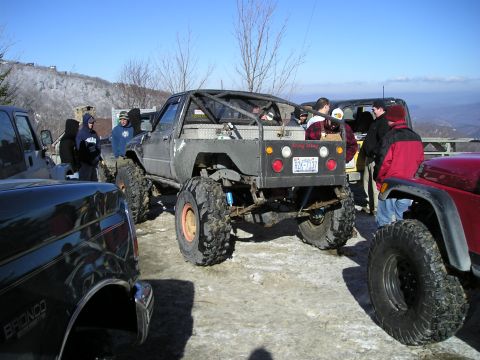 1996 Ford Bronco - Several off-road vehicles gathered on a mountain overlook on a clear winter day.