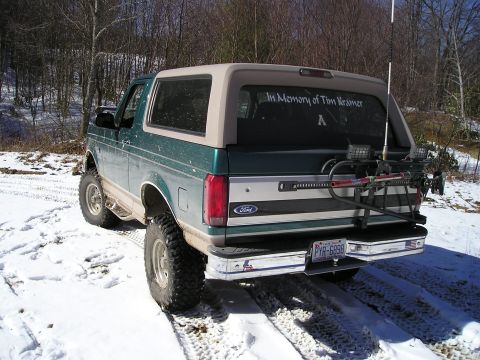1996 Ford Bronco - This 1996 Ford Bronco is seen in a snowy, wooded area, a memorial decal on the rear window and a rack with equipment mounted on the tailgat…