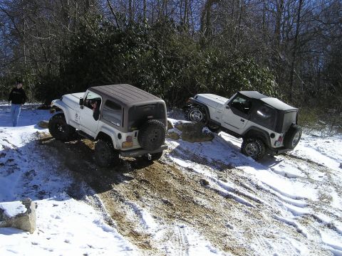 1996 Ford Bronco - Two Jeeps tackle a challenging snowy and muddy off-road course.