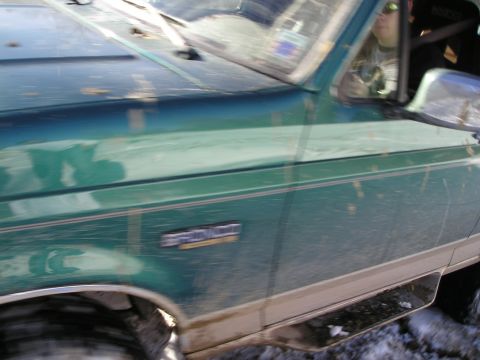 1996 Ford Bronco - A green Ford Bronco with two-tone trim is visible from the side.
