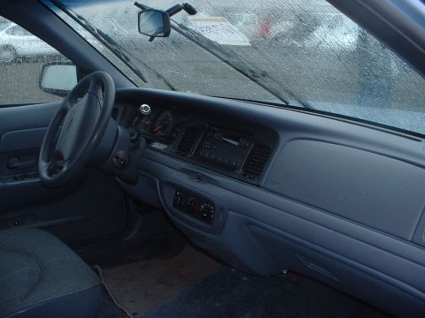 1999 Ford Crown Victoria - The interior of a 1999 Ford Crown Victoria is shown, with a view of the dashboard and steering wheel.