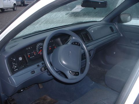 1999 Ford Crown Victoria - The interior of a 1998 Ford Crown Victoria, a blue dashboard and steering wheel.