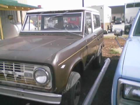 1989 Ford Bronco - This classic Ford Bronco is parked outdoors next to another vehicle.