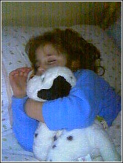 1993 Ford Bronco - A child sleeps soundly while embracing a plush toy dog.
