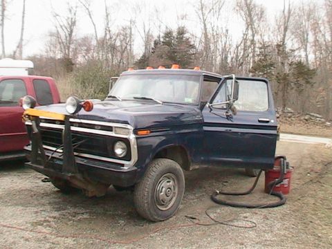 1977 Ford F-250 - A 1977 Ford F-250 is parked outside with its driver's door open and a shop vac connected.