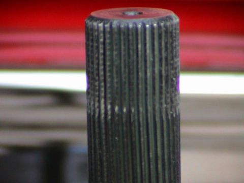 1979 Ford Bronco - A close-up view of a splined shaft, possibly a vehicle component, with distinct purple markings visible.