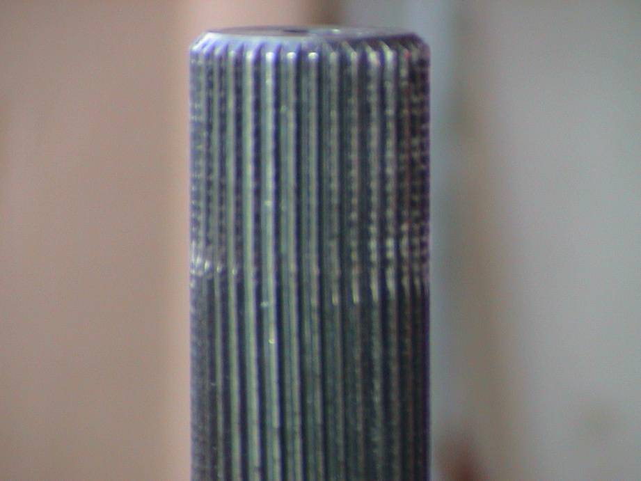 Close-up of a splined shaft with a ribbed surface