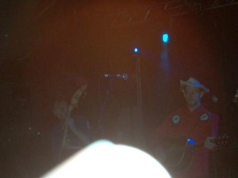 1988 Ford Bronco - Musicians perform on a dimly lit stage with blue spotlights.