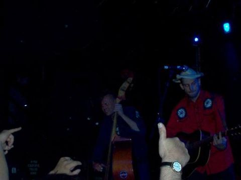 1988 Ford Bronco - Musicians perform on stage with a guitar and double bass under blue stage lights.
