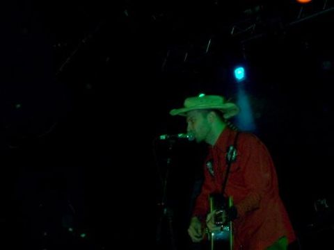 1988 Ford Bronco - A musician performs on stage, illuminated by colored lights.