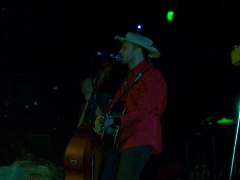1988 Ford Bronco - Musicians perform live on stage with guitars and bass.