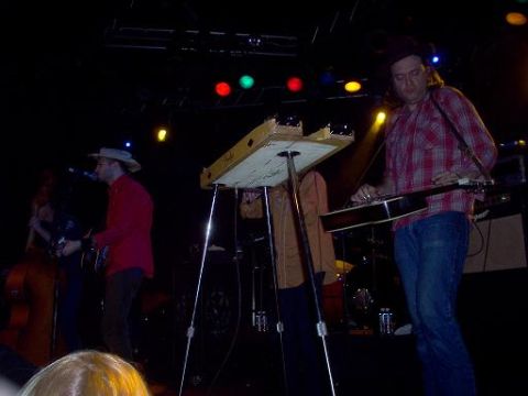 1988 Ford Bronco - A band performs live on stage under colorful lights, with musicians playing various instruments.