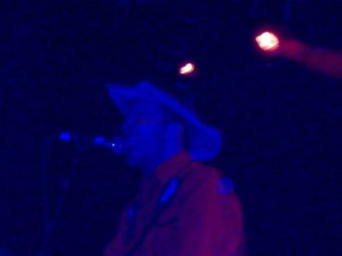 1988 Ford Bronco - A person in a cowboy hat and orange shirt is visible under stage lighting.