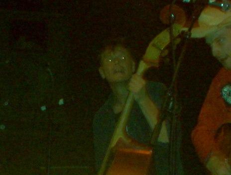 1988 Ford Bronco - Two musicians perform on stage with an upright bass and guitar.
