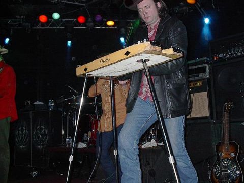 1988 Ford Bronco - A band performs on stage with musical instruments and stage lighting.