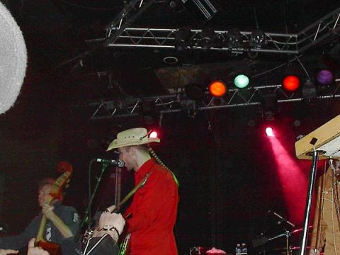 1988 Ford Bronco - Musicians perform on a stage under colorful stage lights.