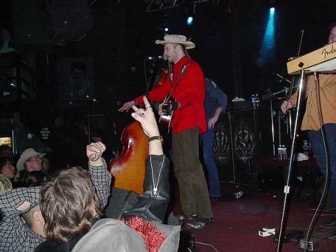 1988 Ford Bronco - A band performs live music on stage, with a double bass player in the foreground.
