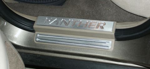 2001 Mercury Grand Marquis - Close-up of a car's interior door sill with the word 'PANTHER' embossed on a metal plate.