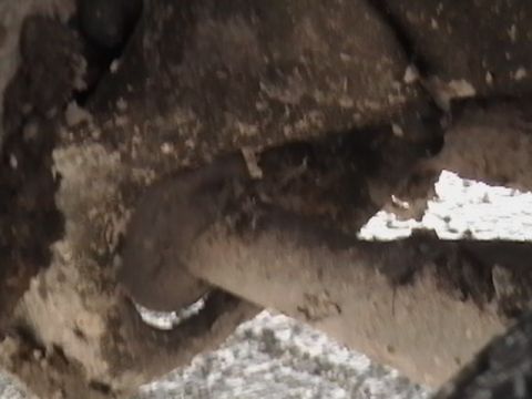 1986 Ford Bronco - A close-up view of a dirty suspension part, with the Supermotors logo visible at the bottom right.