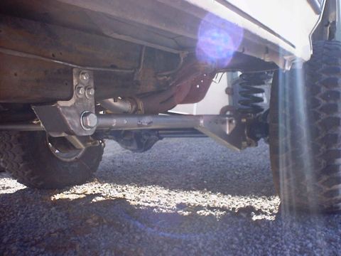1988 Ford Bronco - Custom radius arms and suspension components are visible on the undercarriage of this vehicle.