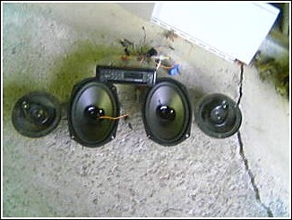 1993 Ford Bronco - Car stereo head unit and speakers are shown on a concrete surface.