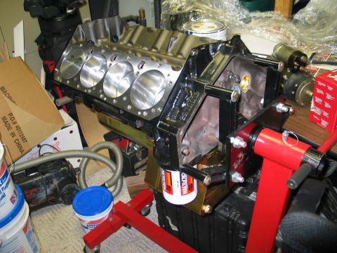 1981 Chevrolet Corvette - Engine block assembly, likely for a performance rebuild, is shown on a stand with an oil filter and various shop items in the background.