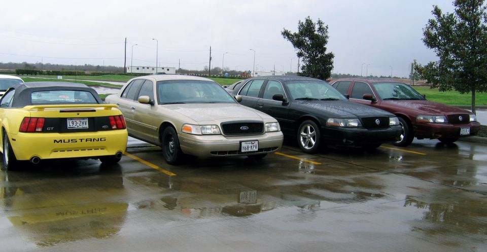 Gold 2000 Ford Crown Victoria parked in a lot with other vehicles