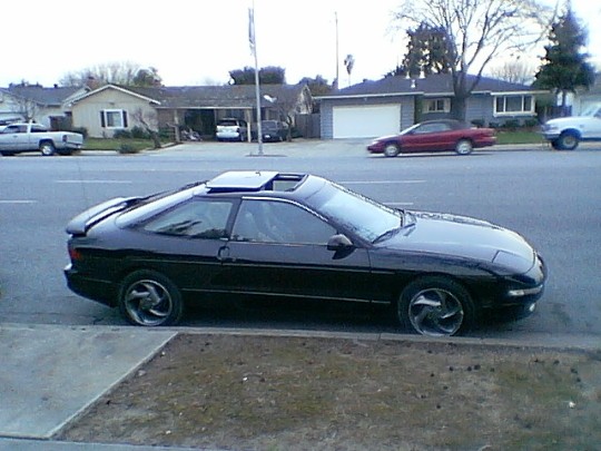 Black 1993 Ford Probe coupe with sunroof parked curbside